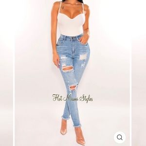 Hot Miami Styles flared ripped high waisted jeans.